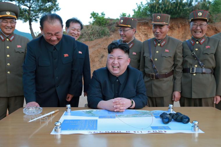 North Korean leader Kim Jong Un reacts during the long-range strategic ballistic rocket Hwasong-12 (Mars-12) test launch
