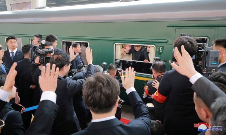 x75849760_REFILEADDING-CITYNorth-Korean-leader-Kim-Jong-Un-waves-from-a-train-as-he-paid-an-unof.jpg.pagespeed.ic.p5FHLwJcs2
